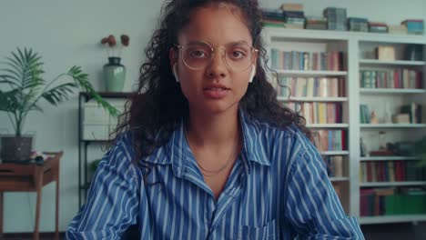 young indian woman freelancer waves hand during video conference camera view