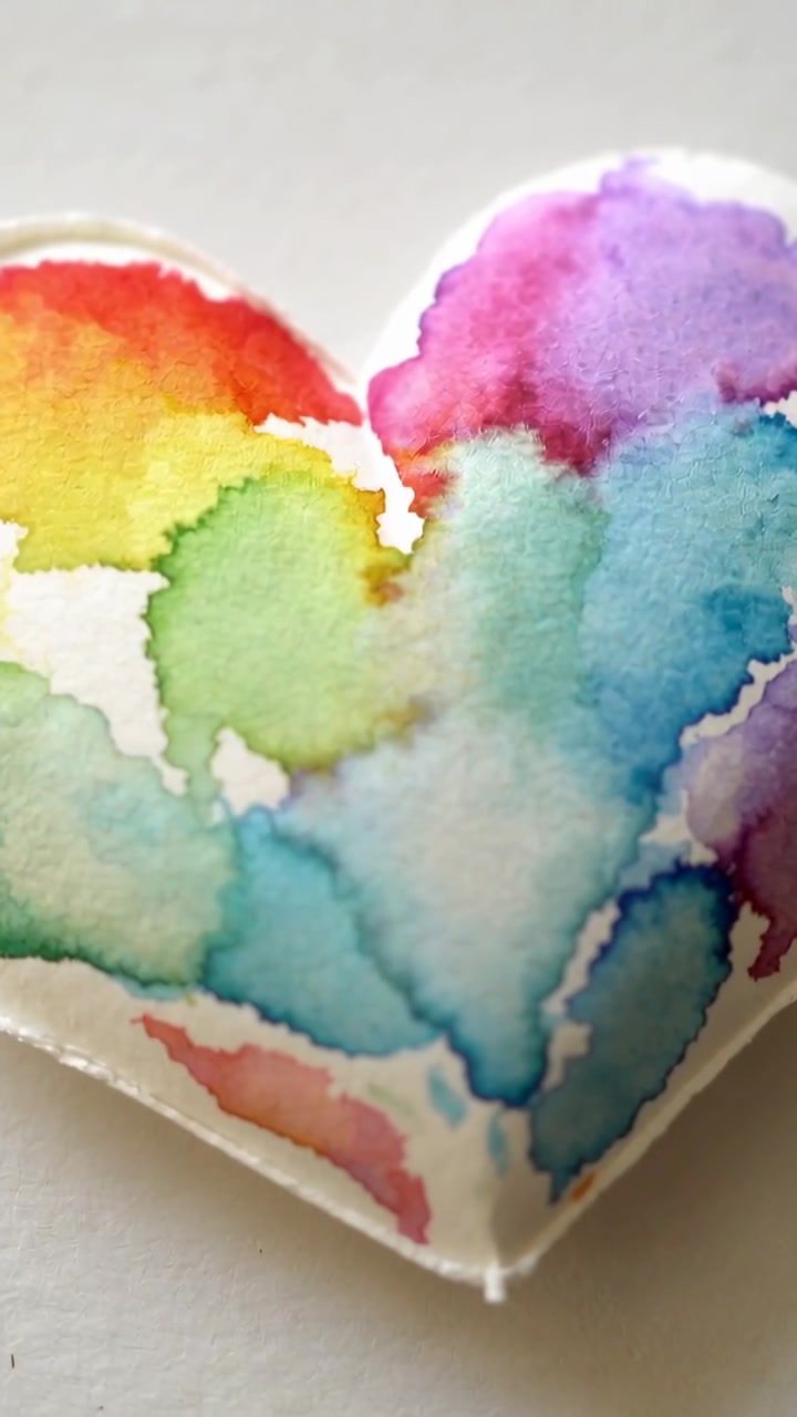 Vertical video: Shifting camera up left, focusing on pale table, showing rainbow heart for display