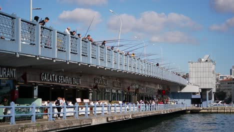 people fishing on the galata bridge in istanbul