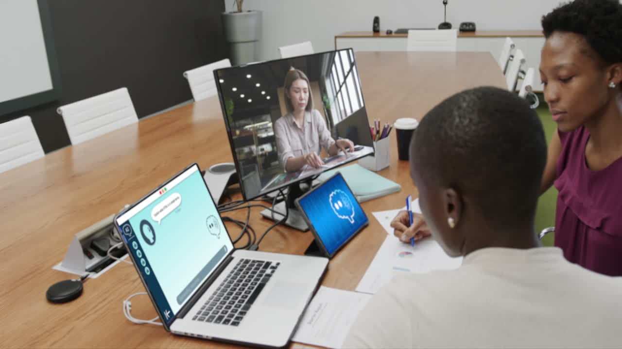 African american businesswomen using computers with data processing in office