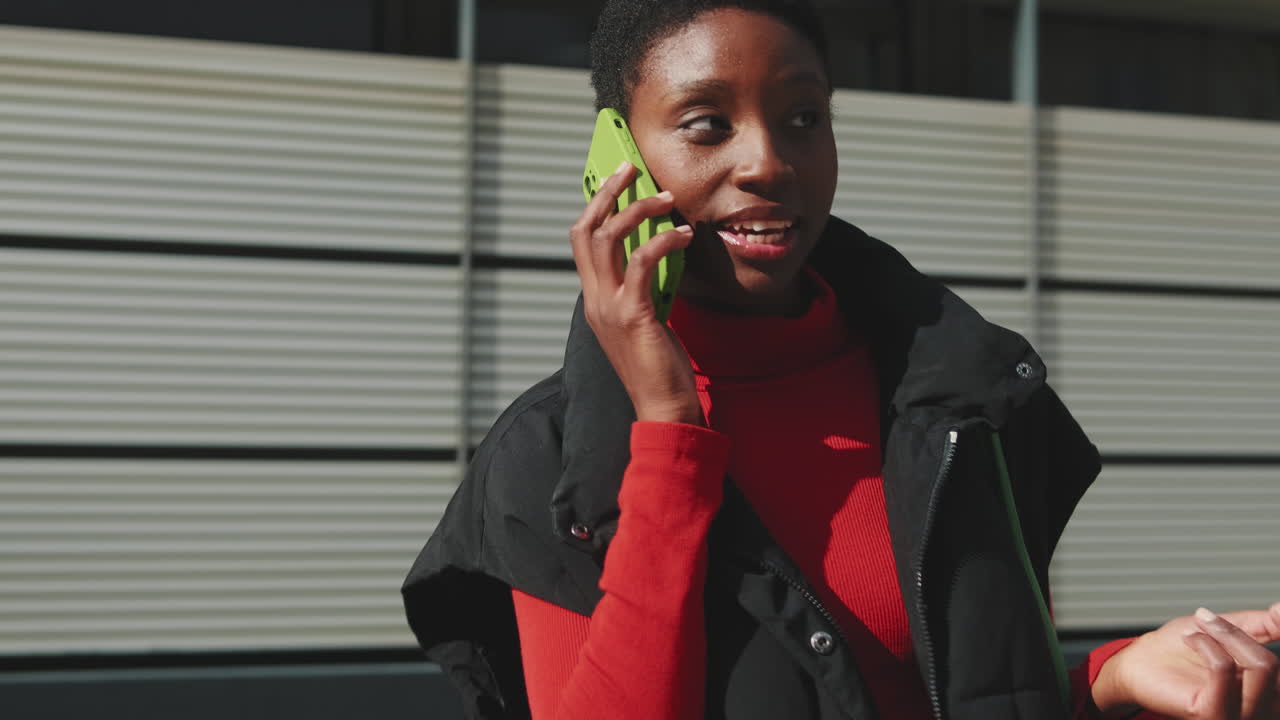 Happy Young African American Woman Talking on Smartphone Outdoors