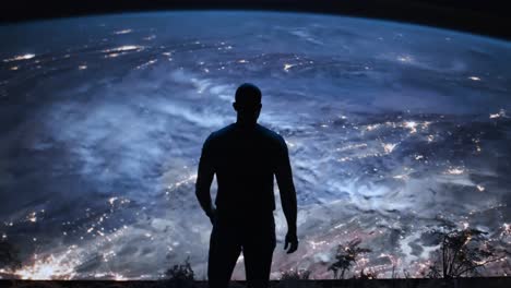 man looking at earth from a high vantage point at night