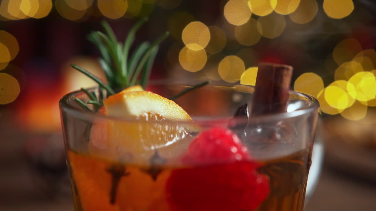 Cup Of Warming Winter Tea with Cloves, Orange, Anise, Rosemary, Raspberry And Cinnamon Stick, Christmas Mood by the Fireplace