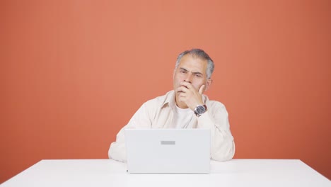 Man-looking-at-laptop-is-thoughtful.