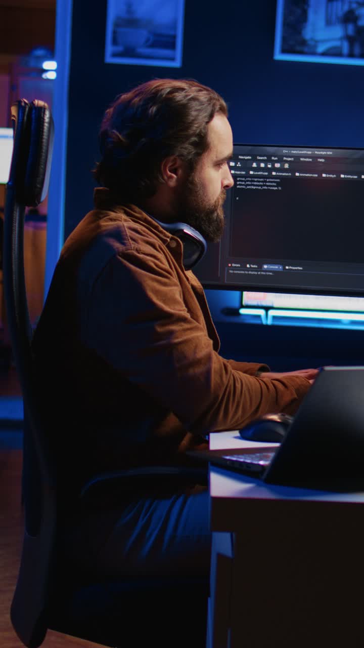 Male Developer Typing Code on Computer at Night