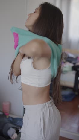 teenage girl getting dressed in bedroom