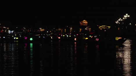 timelapse, small vessel motion, coloured lanterns, dark river scenery