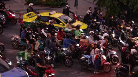 motorbikes and cars at a busy intersection