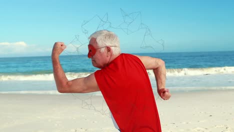 Animation-of-networks-of-connections-over-happy-senior-man-in-red-superhero-cape-exercising-on-beach