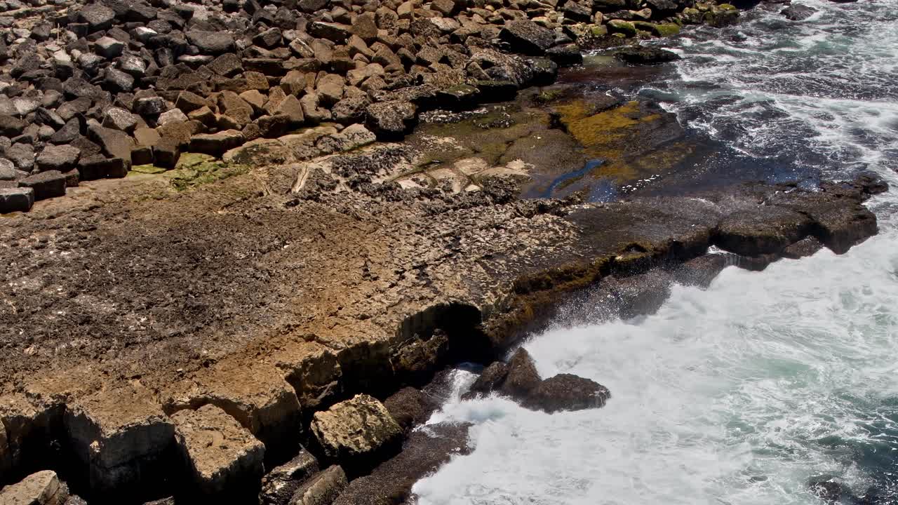 View of rocky coast in Portugal with waves crashing on the shore