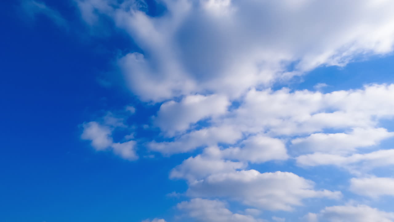 Amazing azure sky with floating clouds. Soft white cloudscape transforming in the atmosphere. Timelapse.