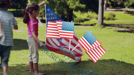 Animation-of-usa-flags-over-happy-biracial-boy-and-girl-running-with-flags-on-grass