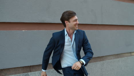 smiling man dancing in modern suit. man celebrating success in business