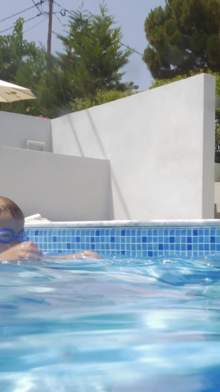 Kids playing in the swimming pool with a beach ball