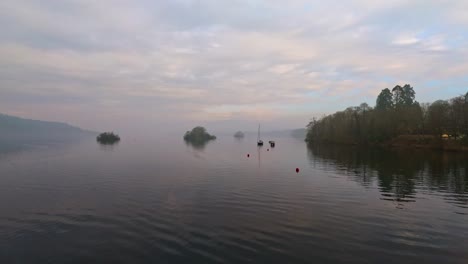 misty scene over lake windermere in the english lake district national park