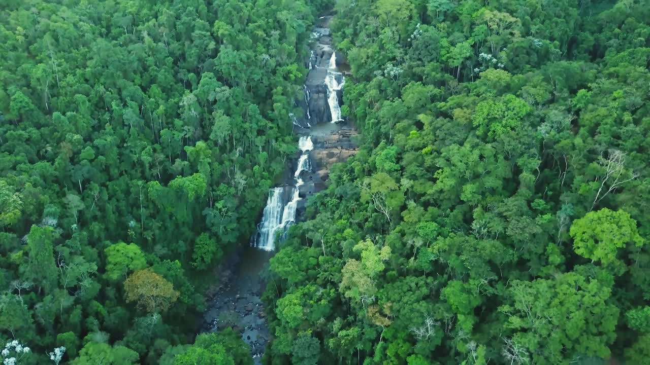 Beautiful tilting aerial shot of huge waterfall in green jungle, Brazil Minas Gerais