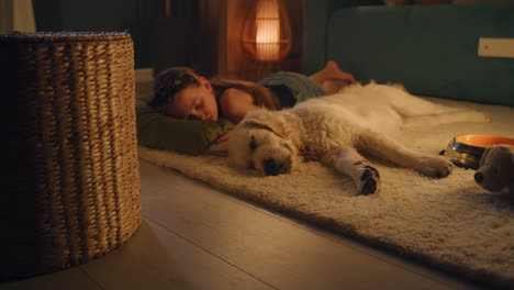 girl and dog sleeping on the floor