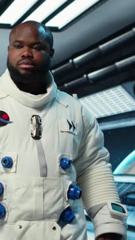 vertical video astronaut walking inside futuristic spacecraft, preparing for scientific mission