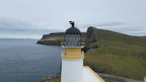 Neist-point-lighthouse-on-the-isle-of-skye-with-cliffs-and-ocean-in-the-background,-aerial-view