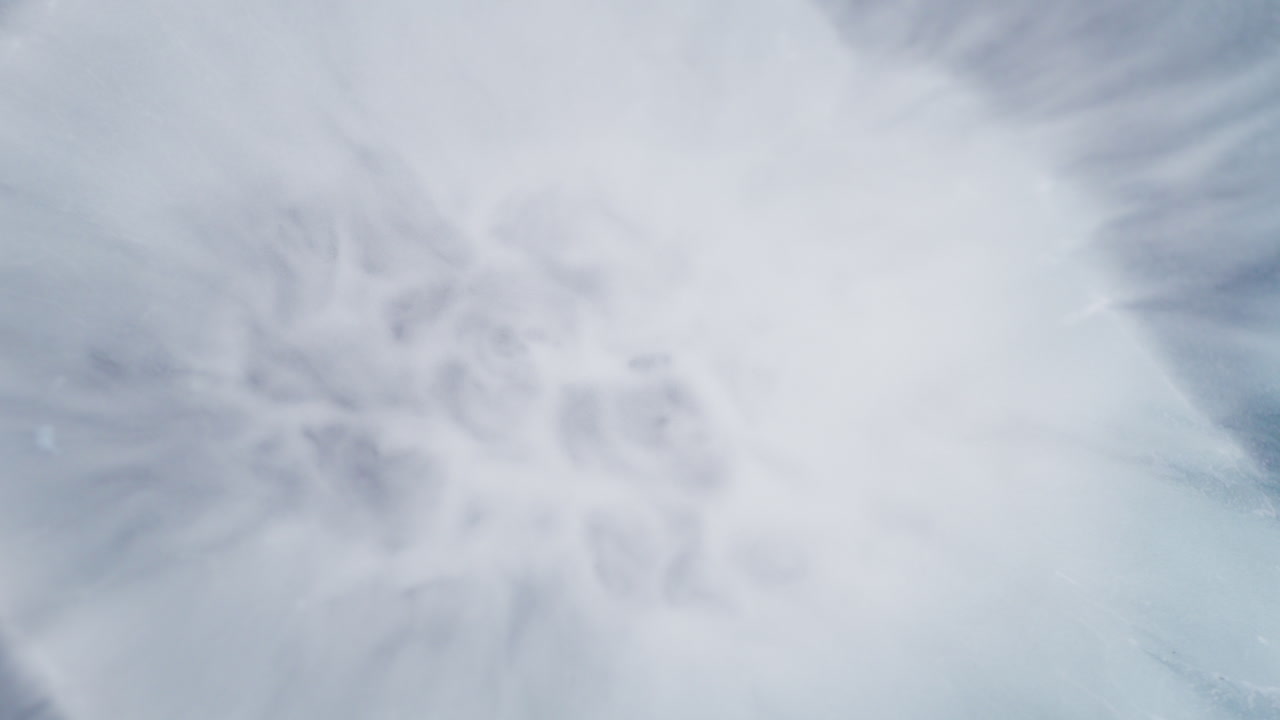 Gray ink motion creating abstract forms. Macro view