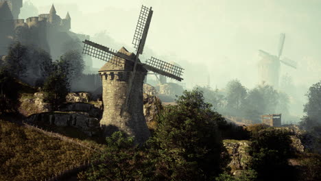 medieval fantasy windmill and castle in a foggy landscape