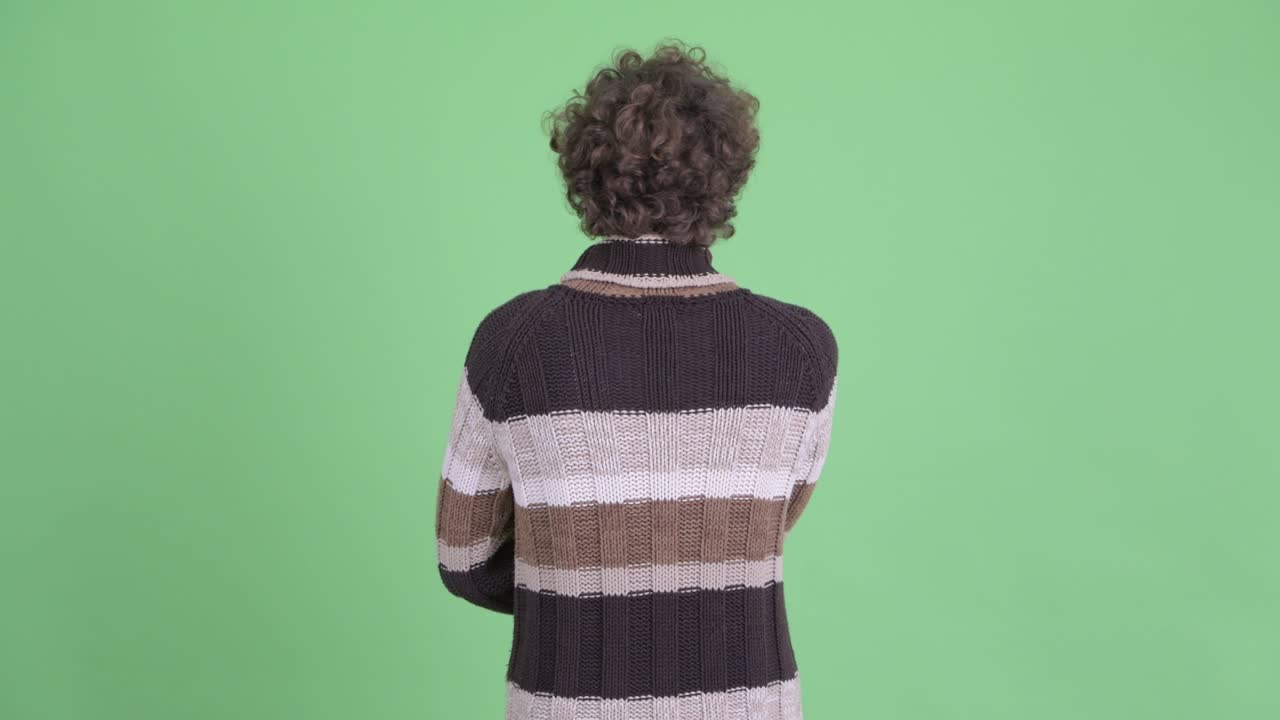 Young handsome bearded man with curly hair