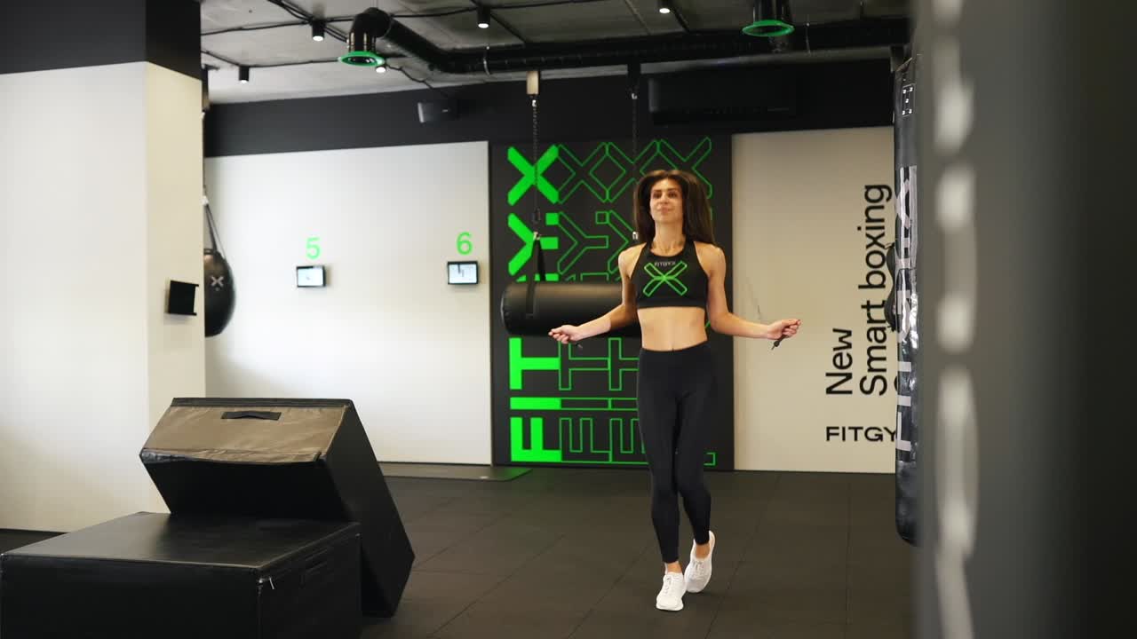 Woman Jumping Rope in Modern Fitness Gym
