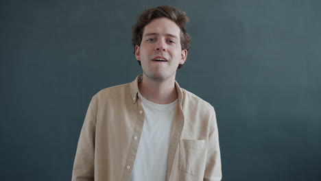 man making phone gesture and smiling