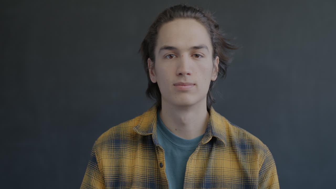 Young Man Smiling and Giving a Thumbs Up