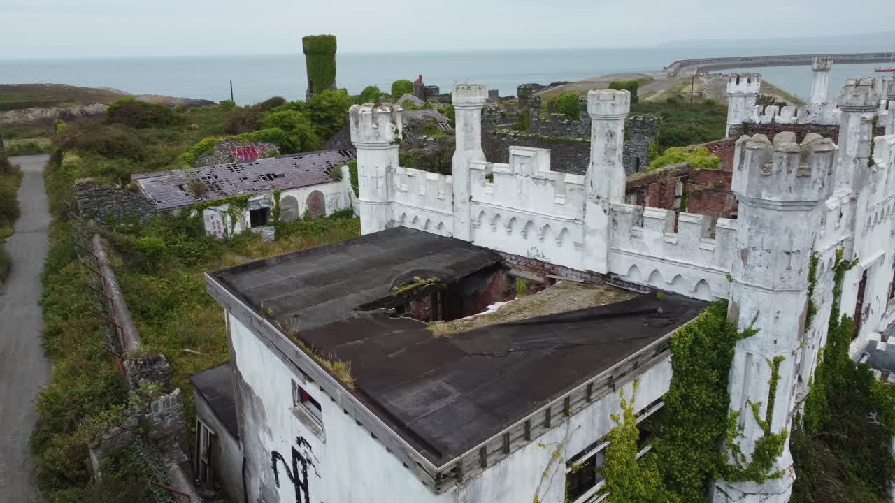 Soldiers point house aerial view across abandoned broken breakwater mansion castle rooftop