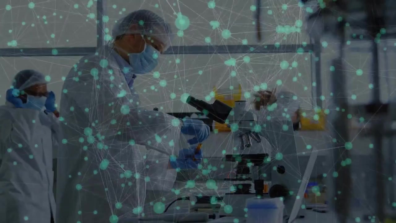 Male scientist taking sample in lab using microscope checking laptop node overlay linking lab data
