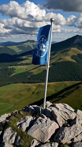united nations flag on mountain peak
