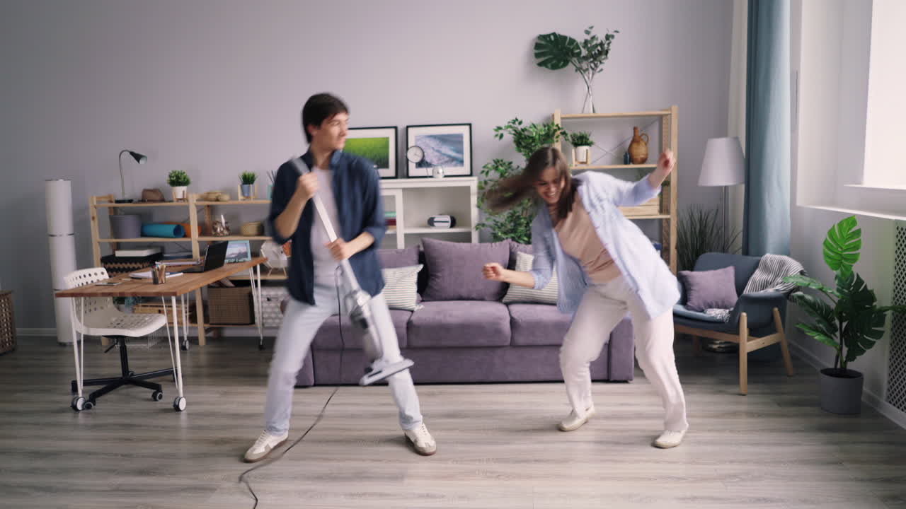 Couple Cleaning and Dancing
