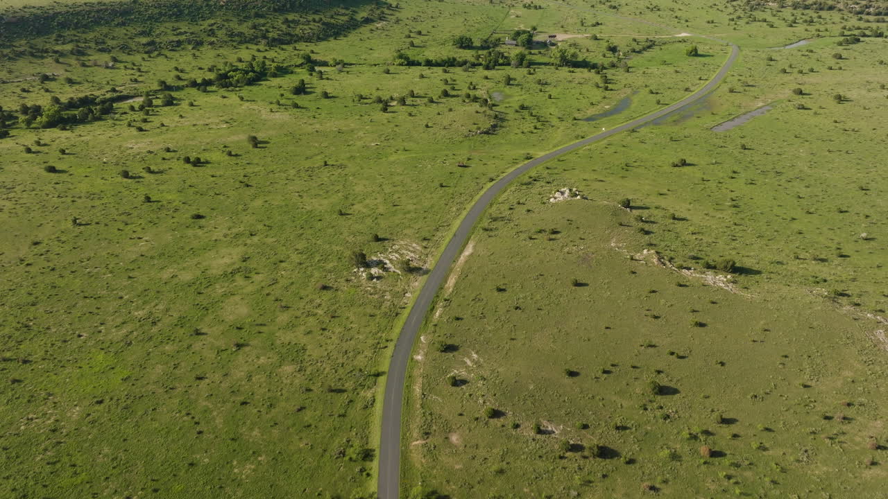 Aerial View of a Green Prairie Landscape with Roads and Water Features
