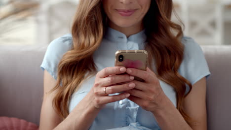 business woman hands typing message on mobile phone at home office.