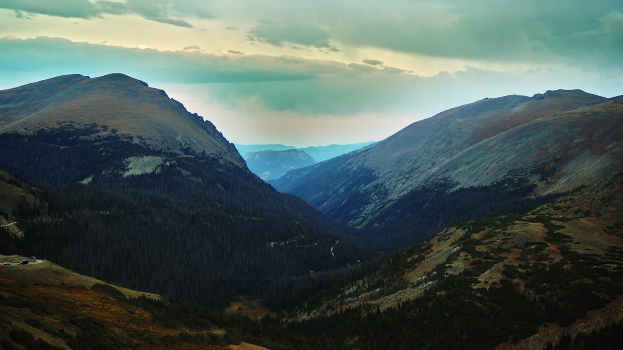 Static shot overlooking beautiful mountains and deep valleys at sunset