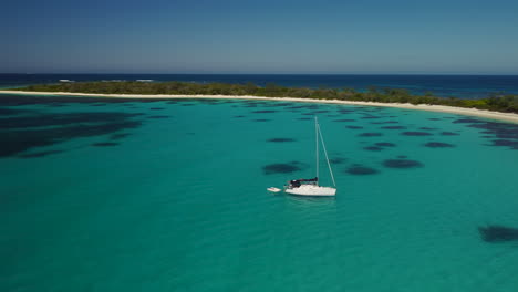 Sailboat-anchored-off-tropical-island-near-Isle-of-Pines