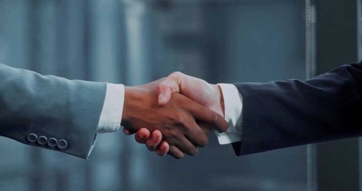 Two Business Professionals Shaking Hands in Modern Office