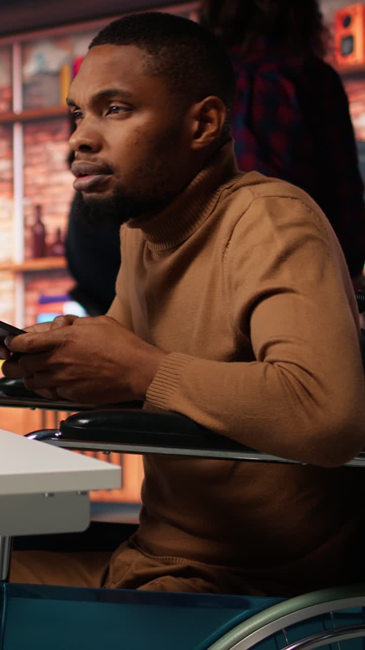 Vertical video Engineer with disability coding AI algorithms in inclusive startup using tablet