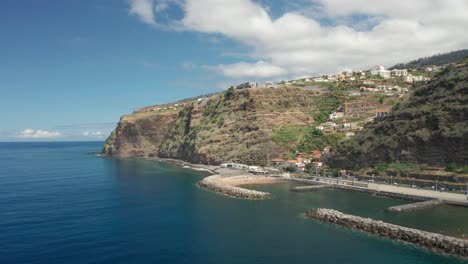 calheta town on top of cliffs with man made beach on shore of madeira