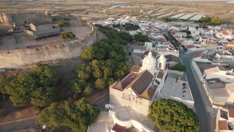 pan right aerial shot around historical church of our lady of martyrs in castro marim, algarve