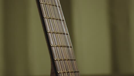 shiny frets of an acoustic guitar after polishing and cleaning using lemon oil cleaner and conditioner