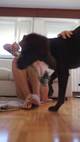 woman playing with her dog indoors