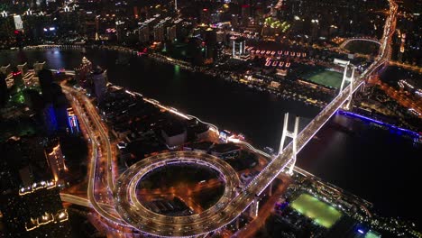 aerial video scene of traffic on nanpu bridge spiral road night sunset time with transportation on land concept, shanghai, china in 4k video