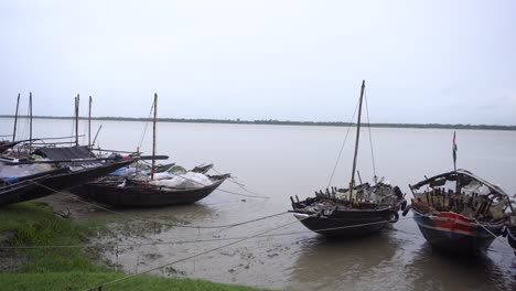 the boats is standing besides the river