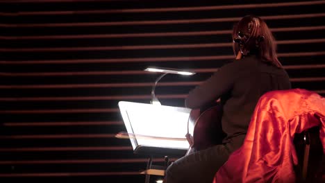 a cellist plays the cello while looking at the sheet music