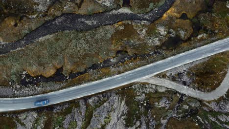 Aerial-footage-of-blue-van-on-small-road-in-Norway