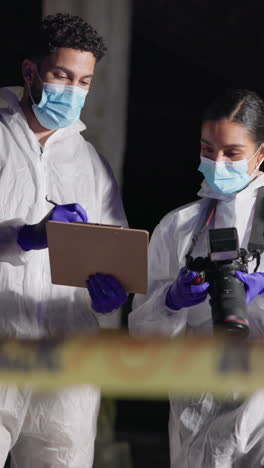 two forensic investigators at a crime scene