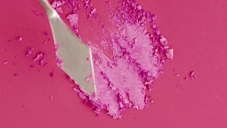 broken pink eyeshadow and makeup spatula