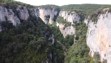 Aerial-drone-footage-of-the-view-of-a-mountainous-natural-cliffs-and-bright-landscape